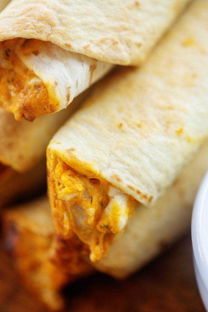 Close up picture of stacked chicken flautas.