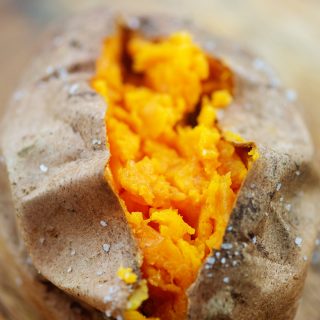 A close up of a split open sweet potato.