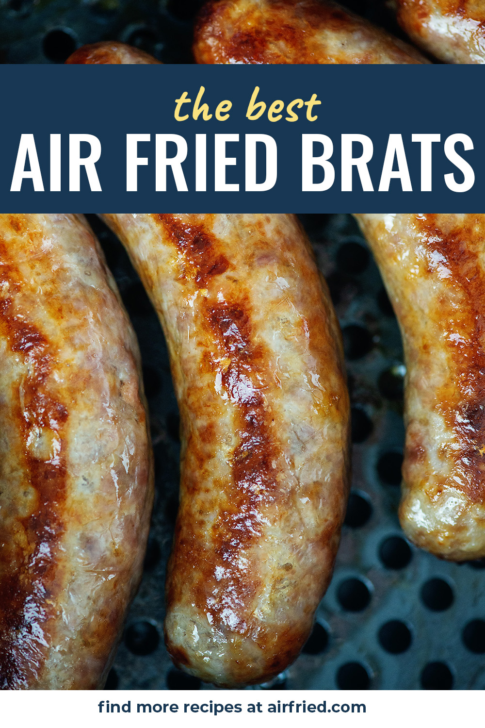 A close up of four bratwursts in an air fryer pan.