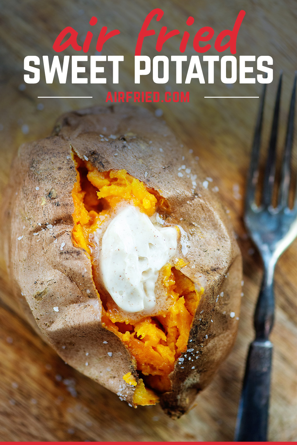 overhead view of a buttered sweet potato on a cutting board.