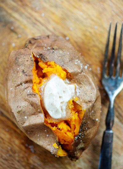 An overhead view of a sweet potatoe topped with butter.