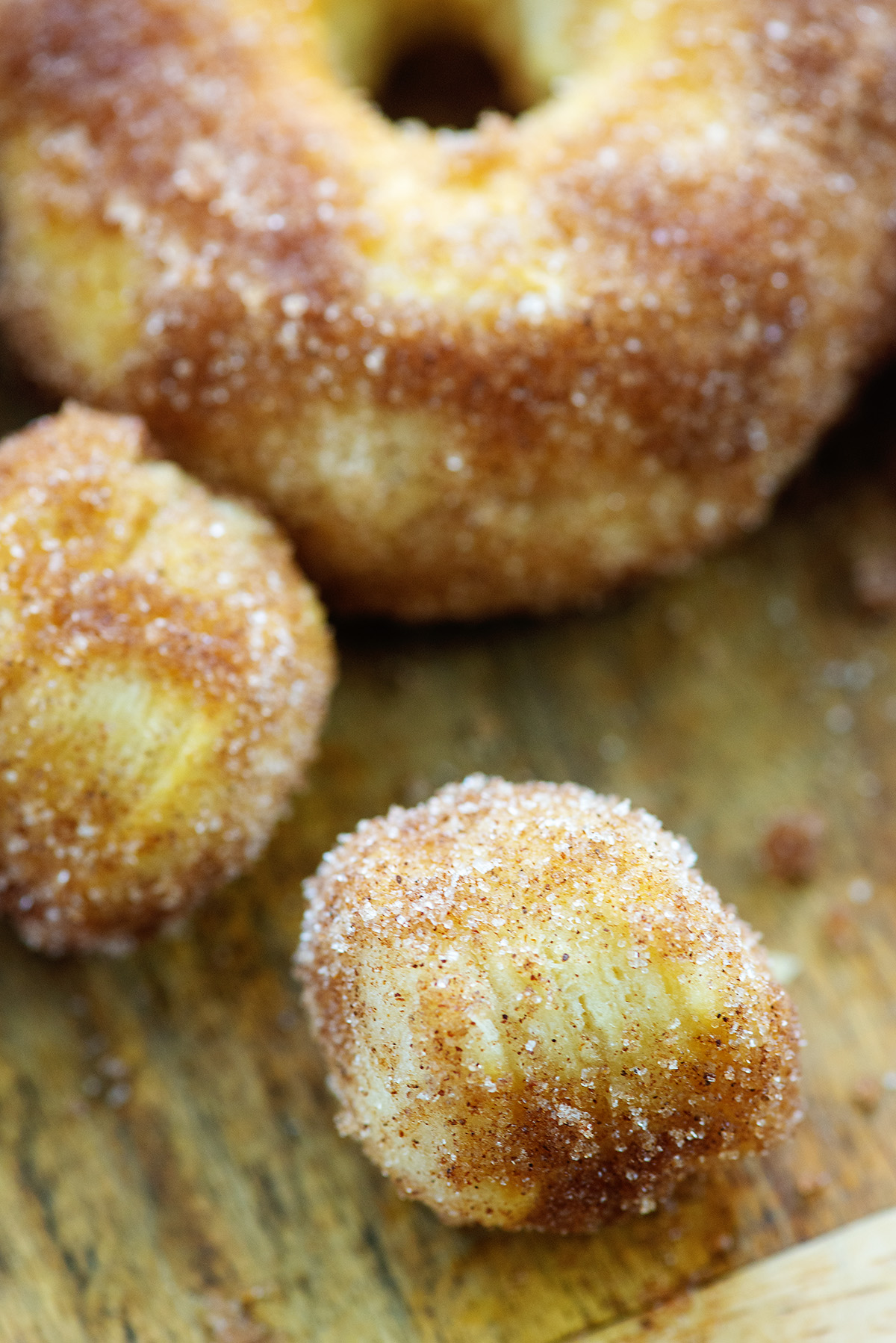 A close up of donut holes covered in cinnamon and sugar