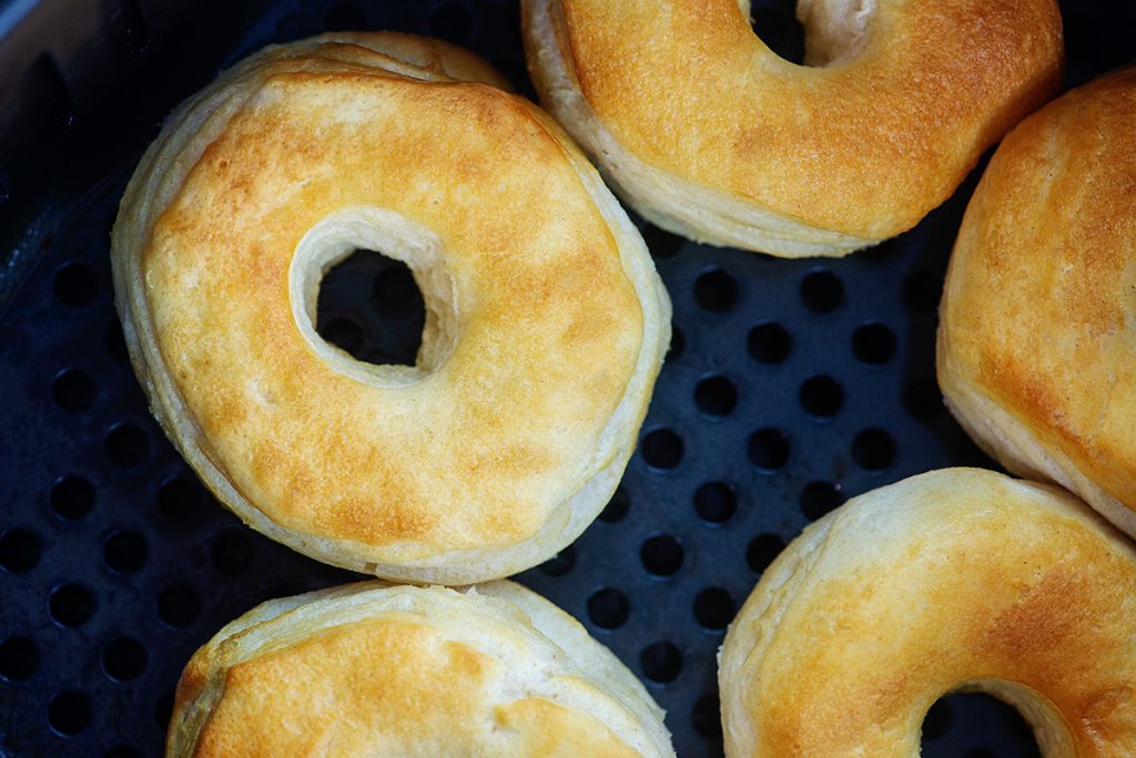 cooked biscuit donuts in an air fryer basket