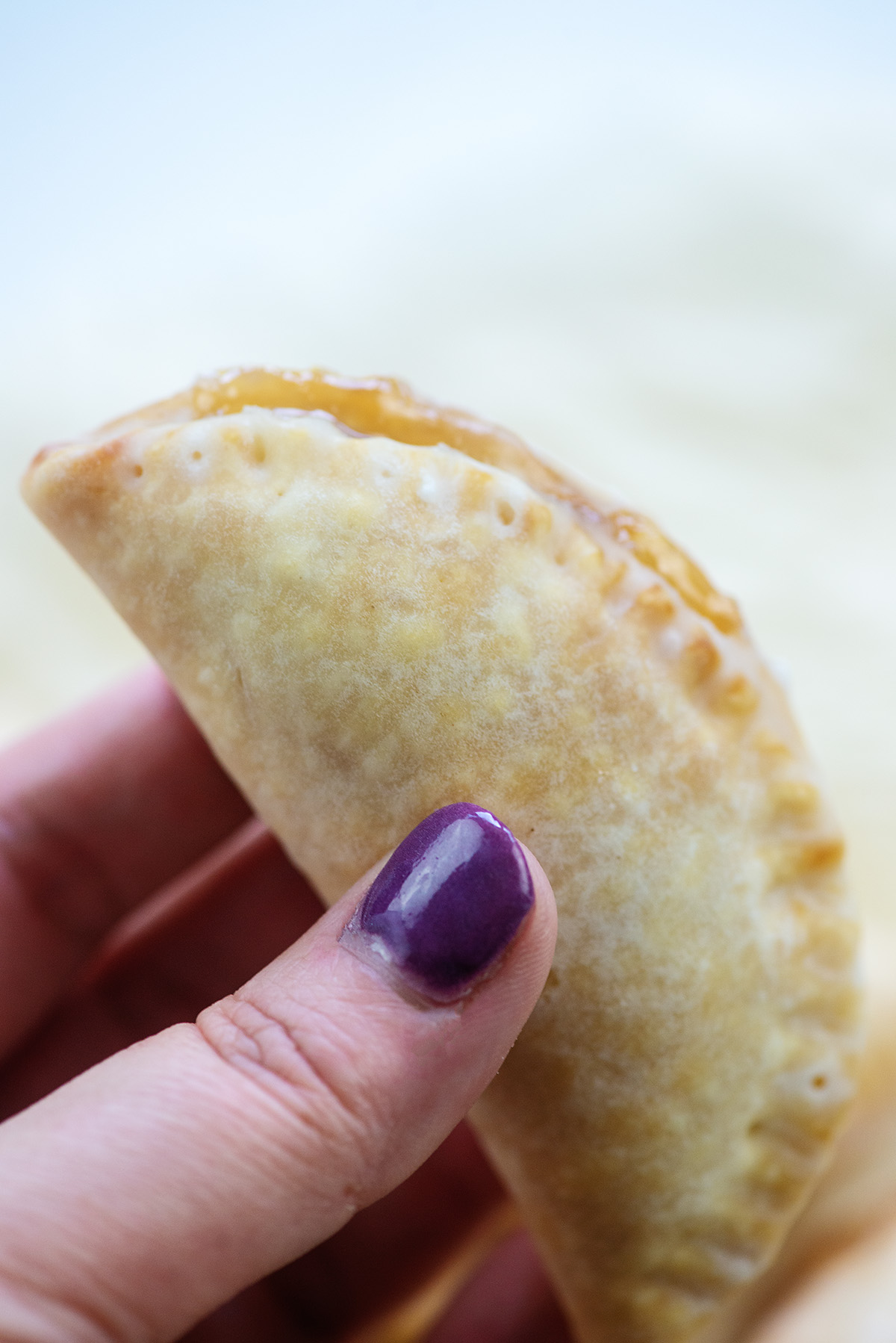 A woman holding a mini apple pie