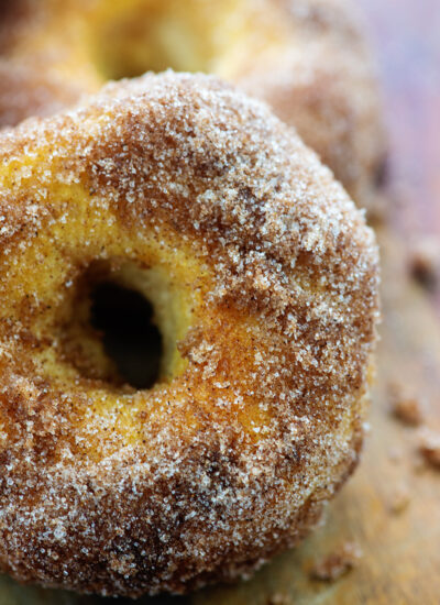A close up of homemade biscuit donuts covered in cinnamon and sugar