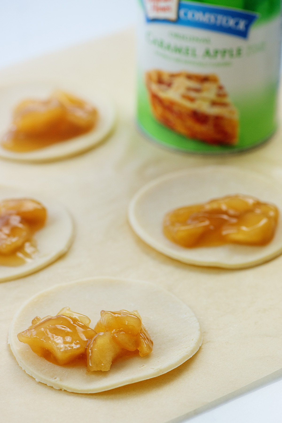 Apple filling in the middle of unfolded pie crust