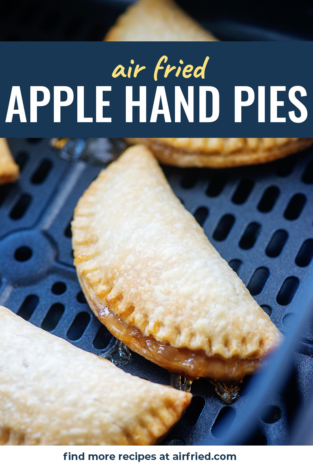 Three apple pies in an air fryer basket.