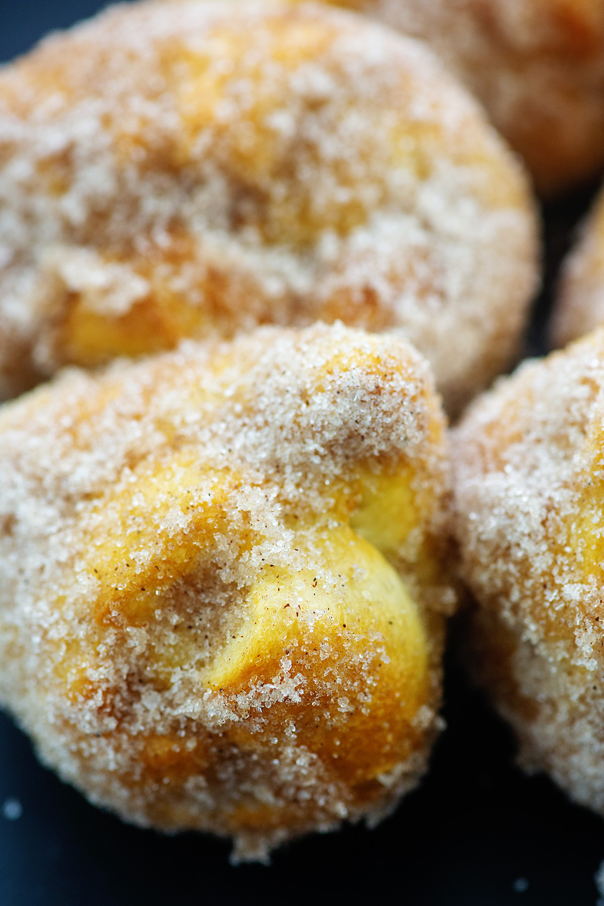 A close up of sugar covered pumpkin donut bombs.