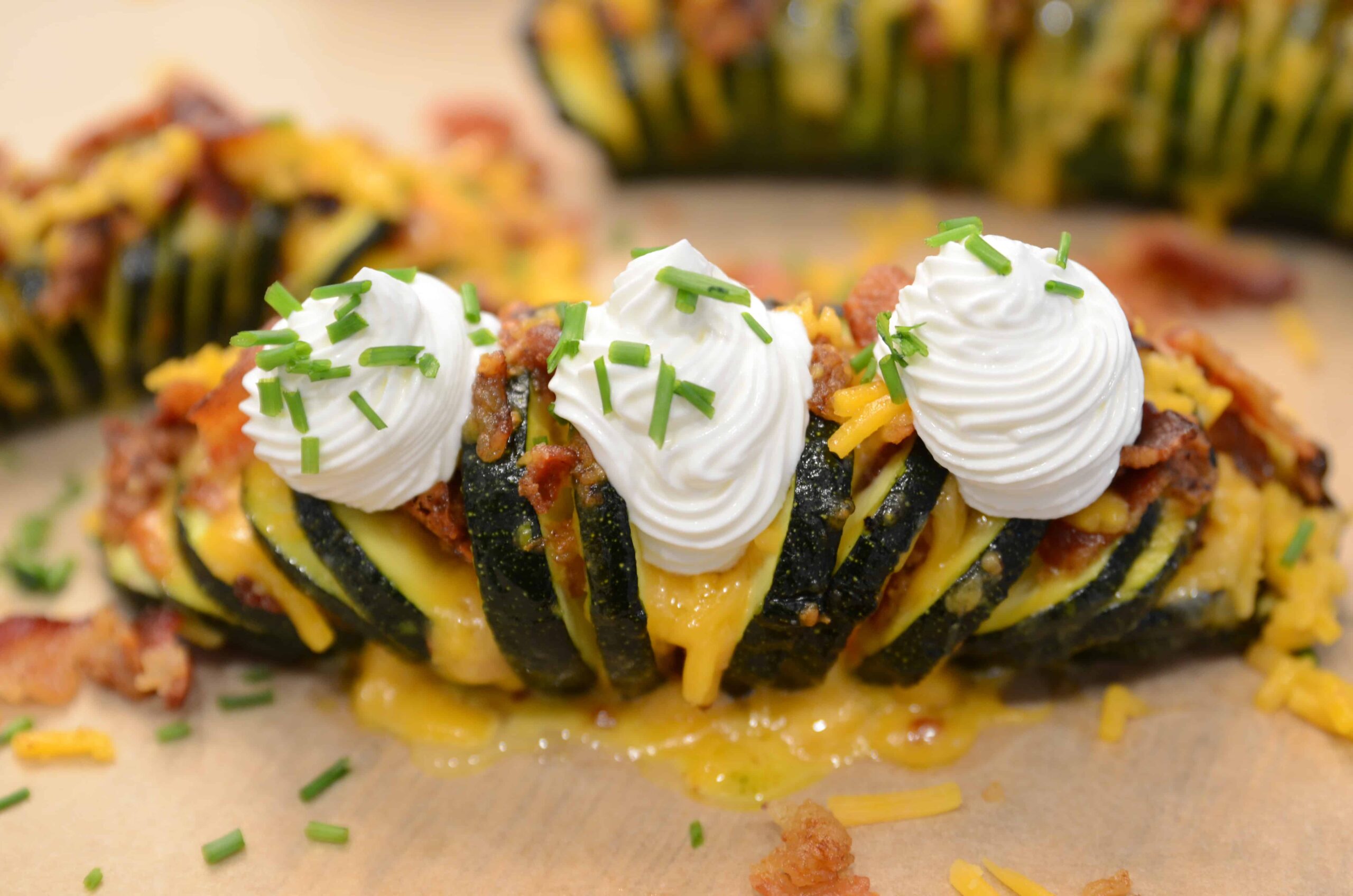 Cheesy hasselback zucchini topped with sour cream