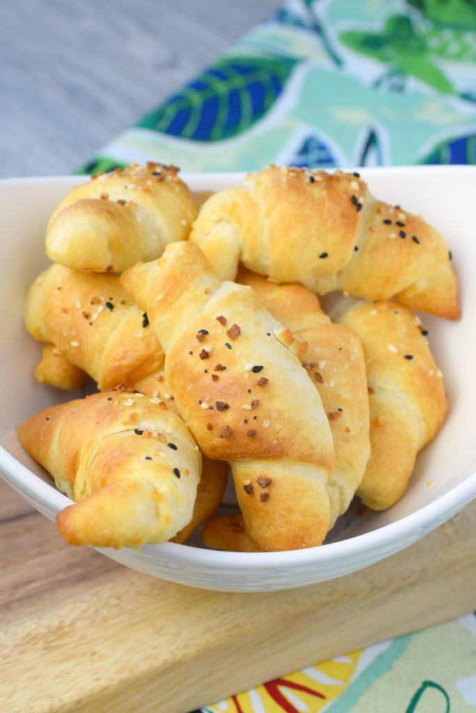Seasoned crescent rolls in a white bowl.