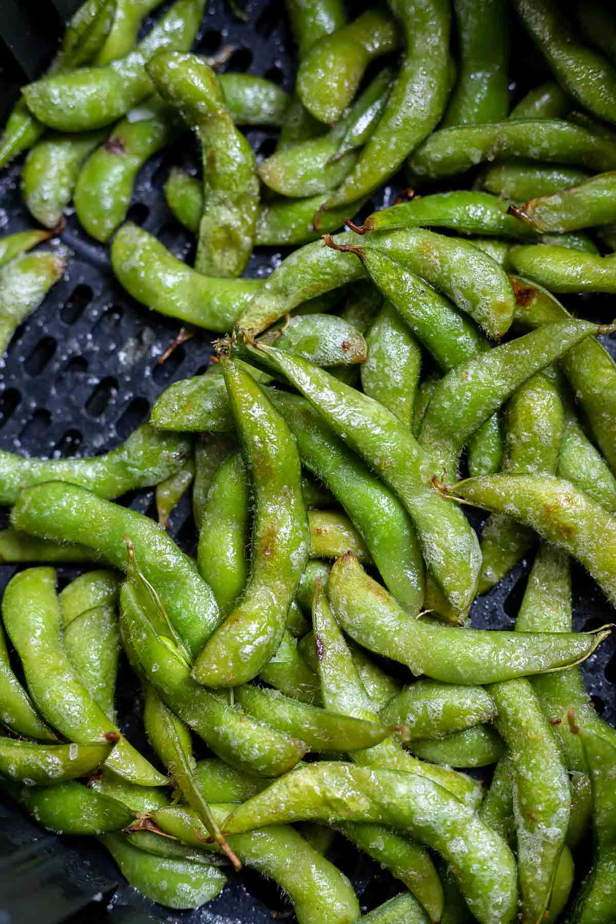 Overhead view of edamame in an air fryer basket