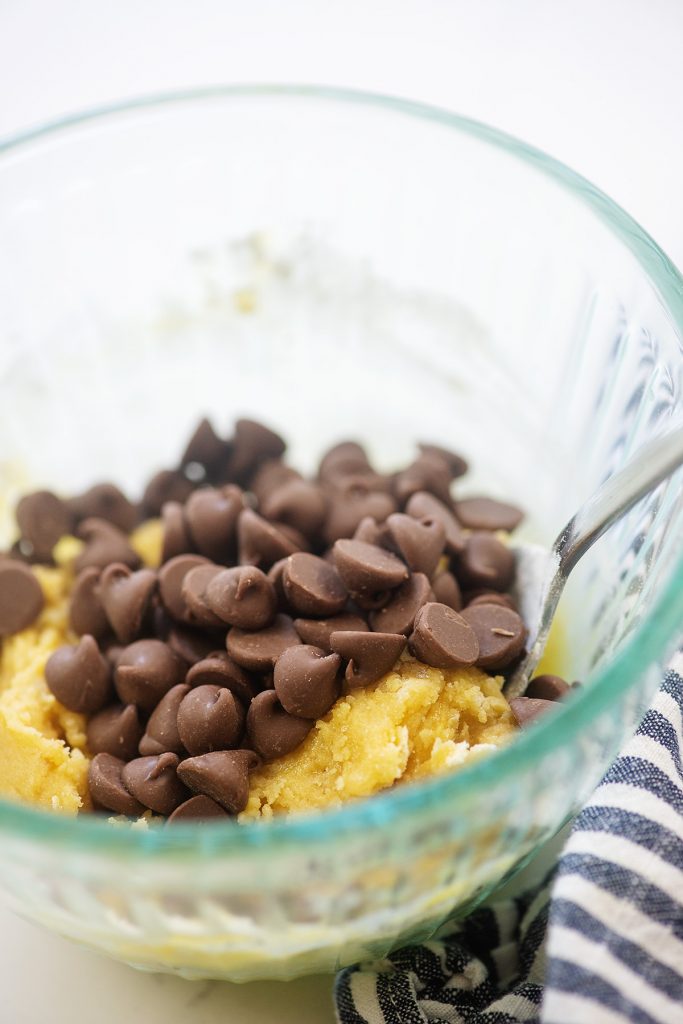 Cookie dough and chocolate chips in a clear glass bowl