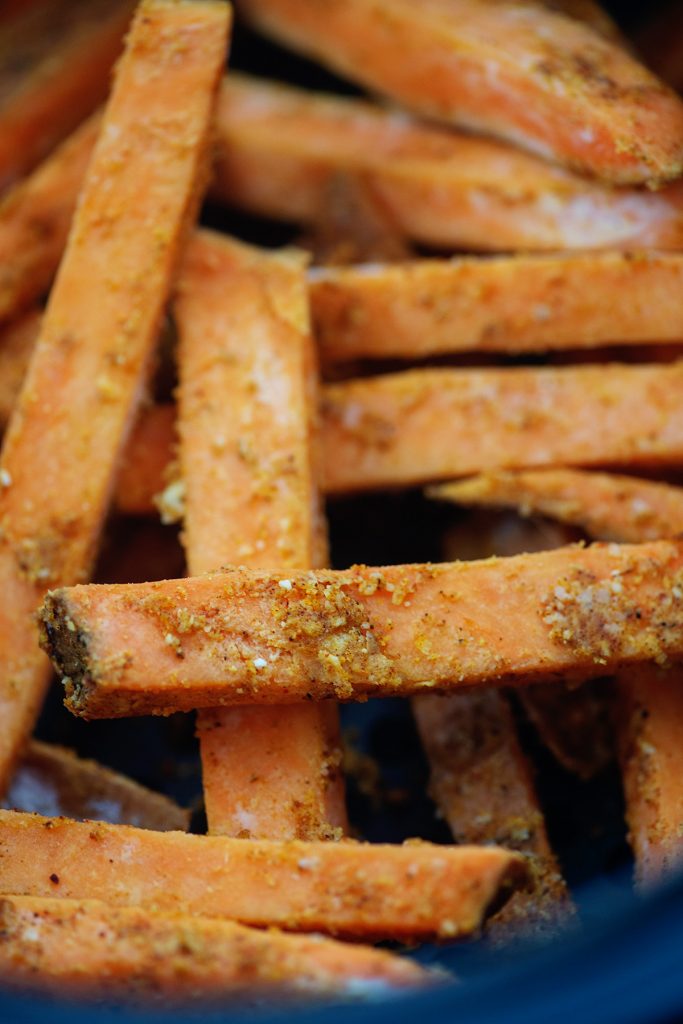 A close up of seasoning on a sweet potato fry