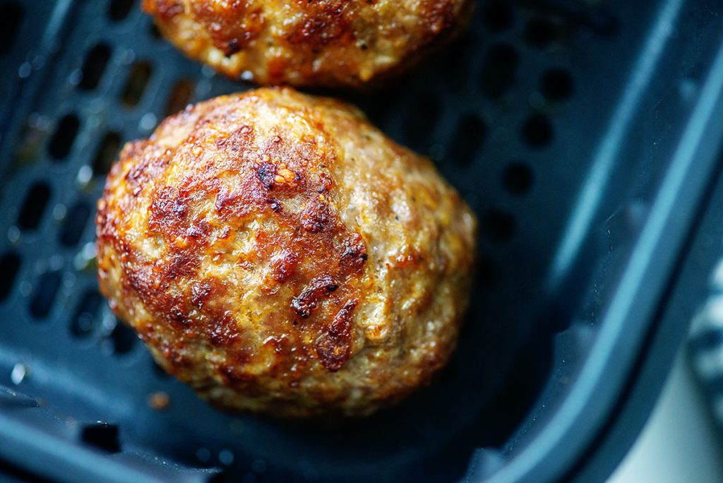 cooked scotch eggs in air fryer basket.