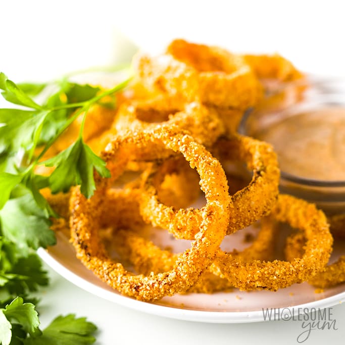 Onion rings on a white plate.