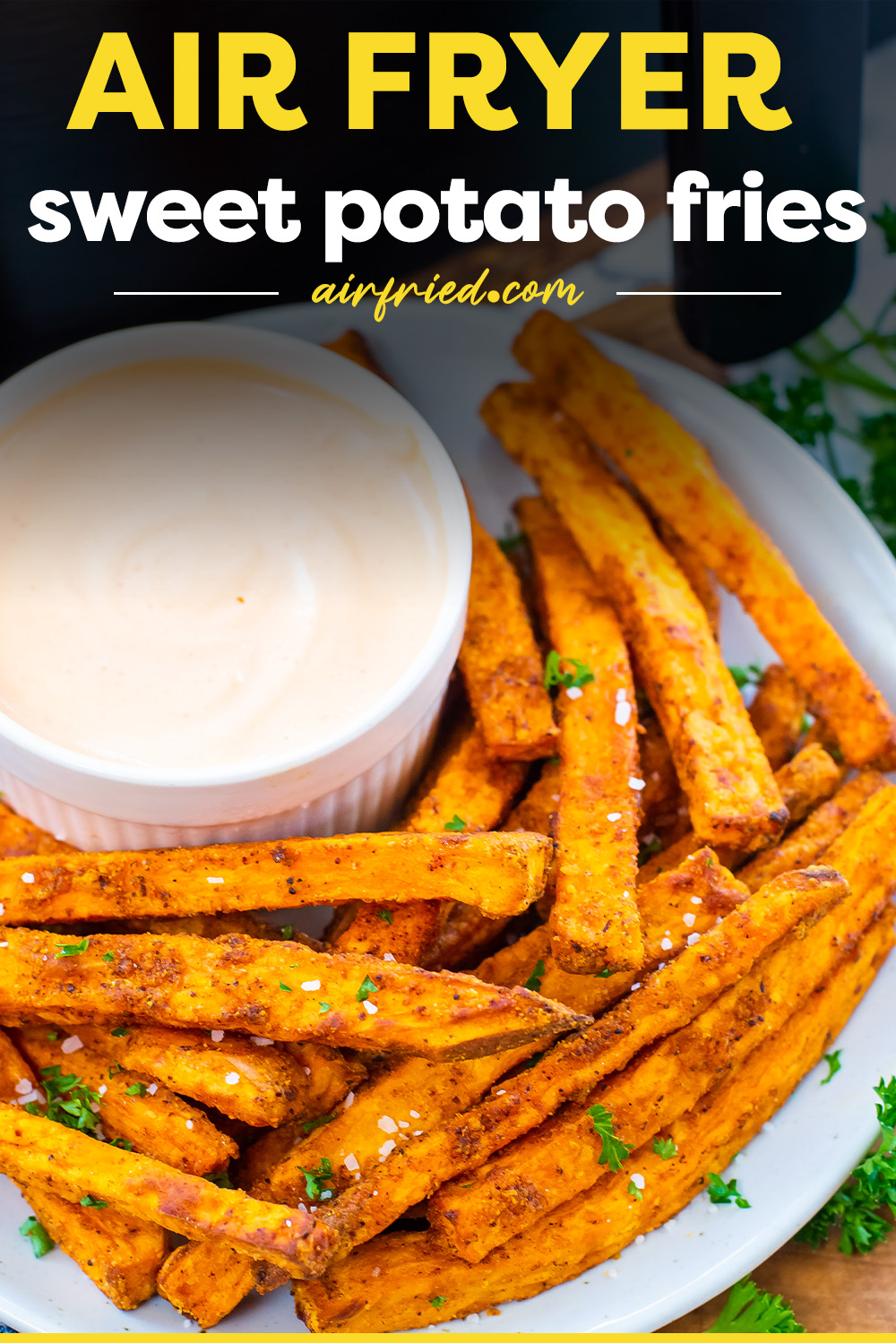 Sweet potato fries on plate with bowl of dip.