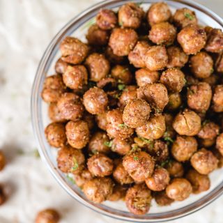 Overhead view of seasoned chickpeas in a small glass bowl