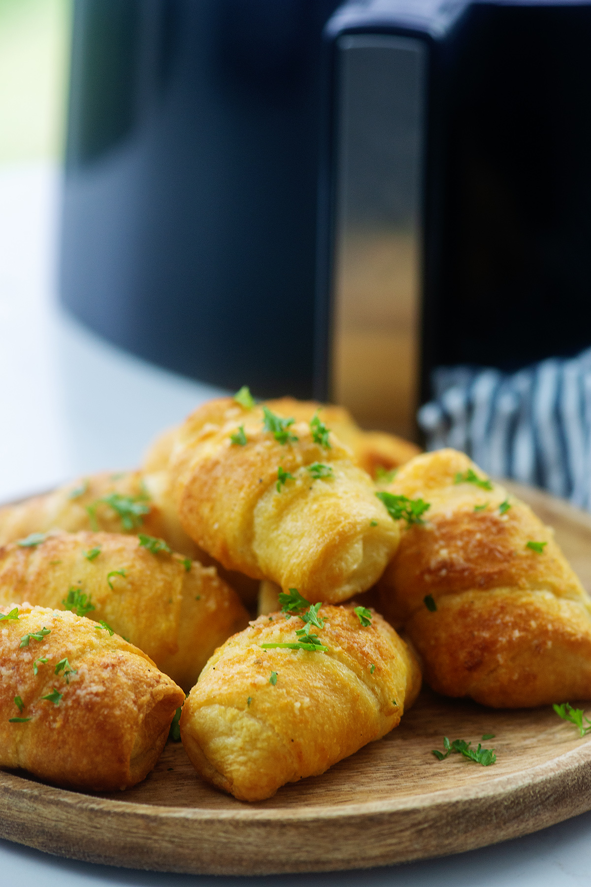 cheesy garlic crescent rolls on cutting board.