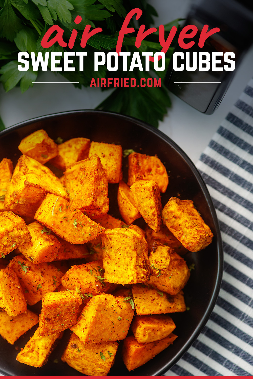 Overhead view of sweet potato cubes on a small black plate
