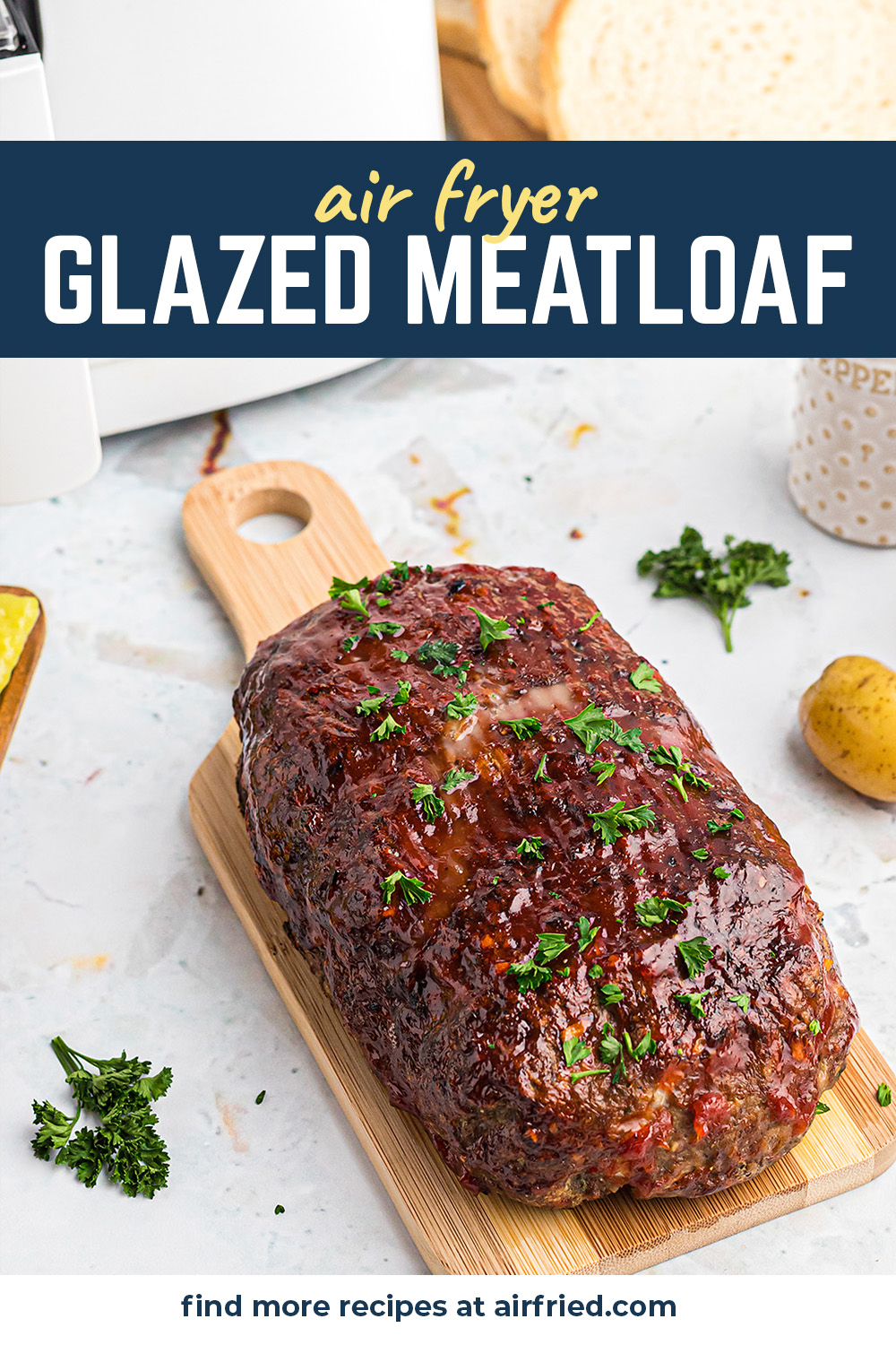 A glazed meatloaf on a small cutting board.