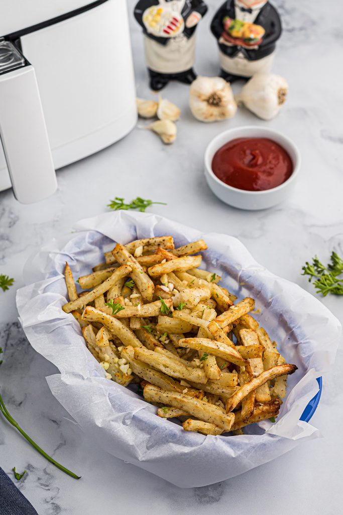 a basket of french fries in front of an air fryer