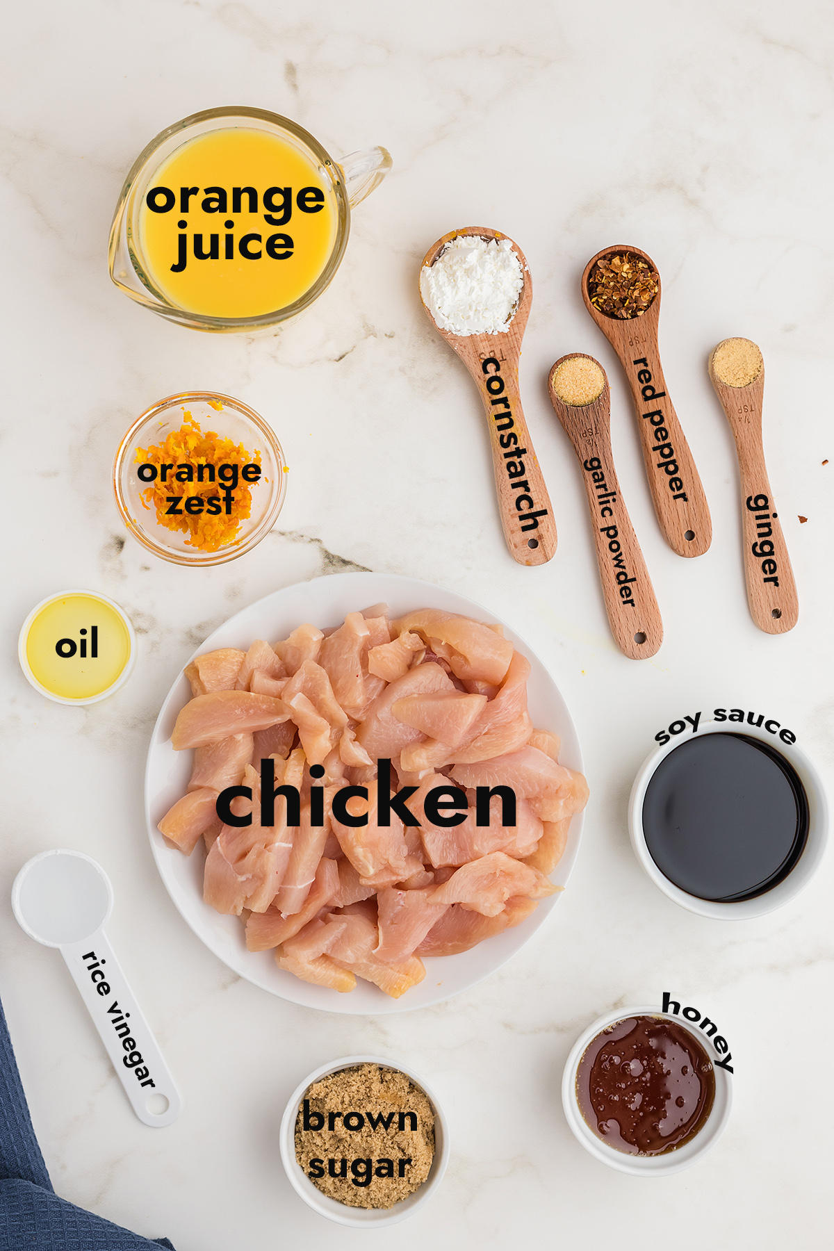 all the ingredients for orange chicken spread out on a countertop