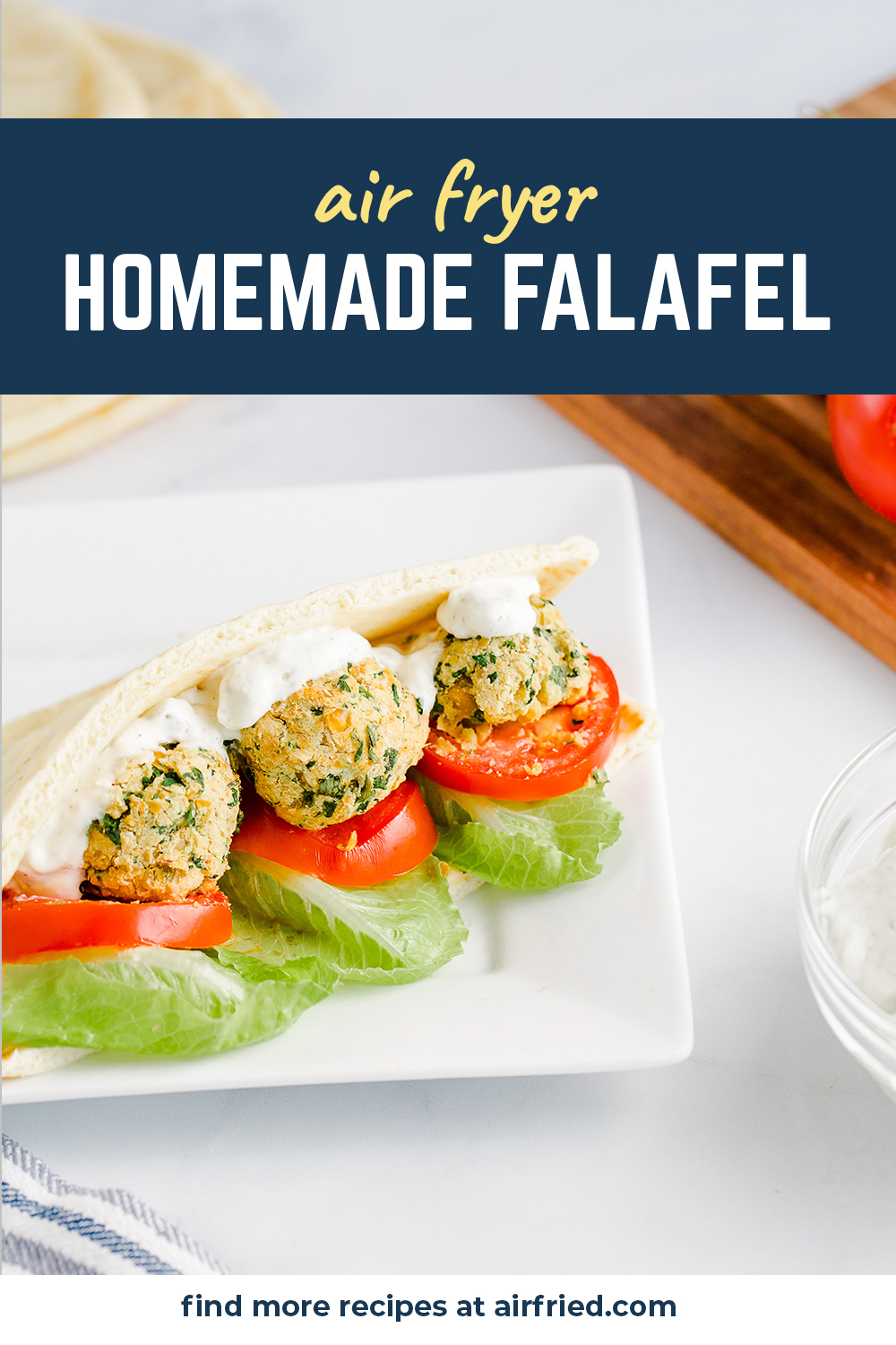 Falafel in a pita wrap with lettuce and tomatoes.