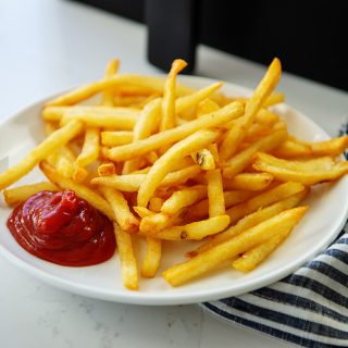 A plate of french fries and ketchup