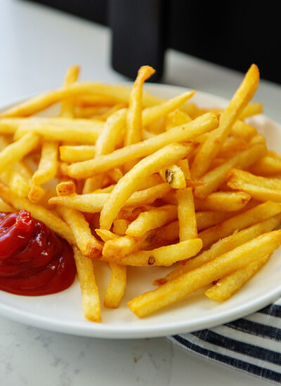 A plate of french fries and ketchup