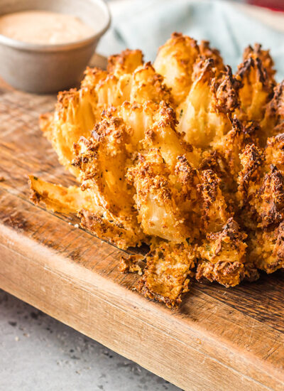 A blooming onion on a wooden serving board