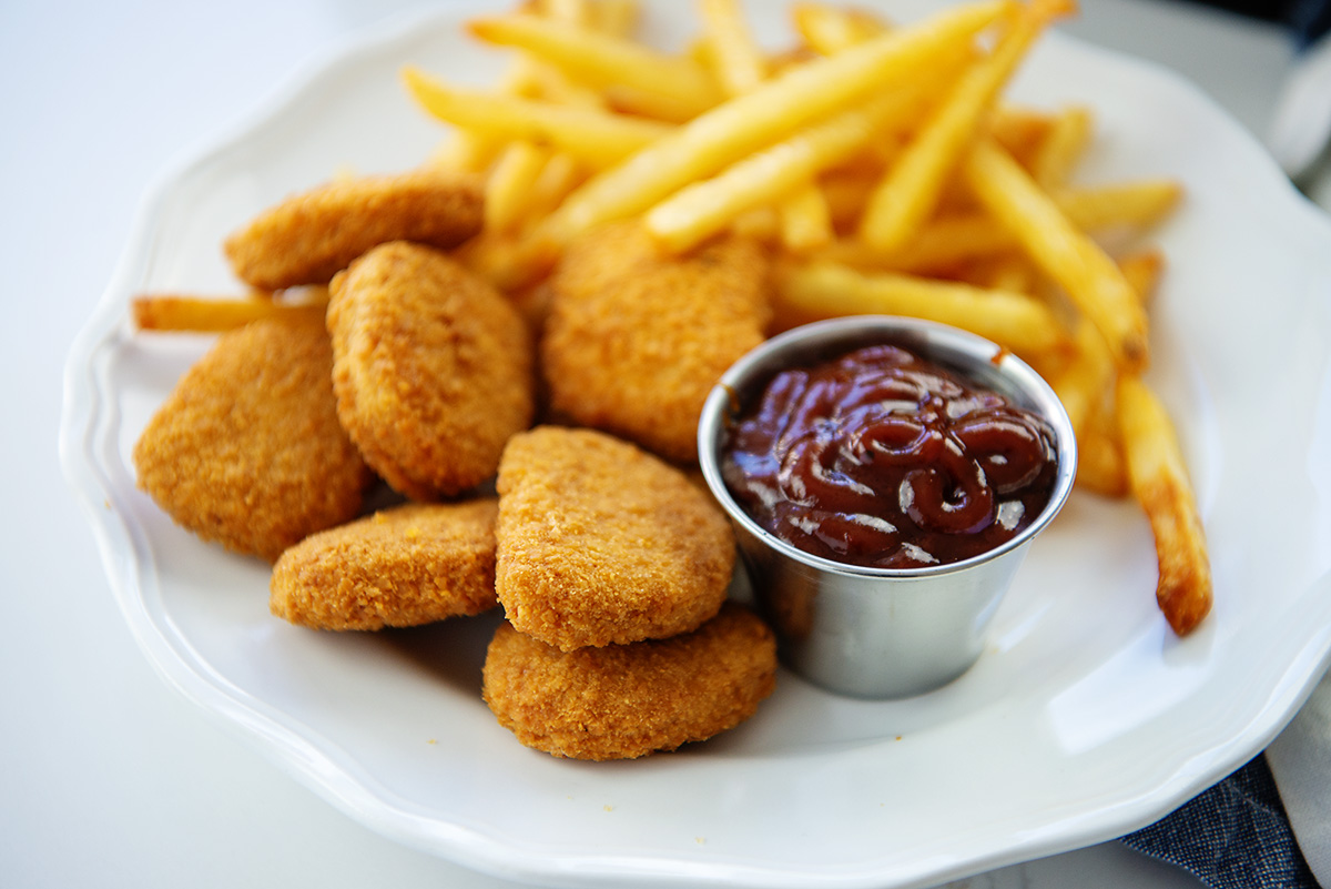 A plate of chicken nuggets and french fries