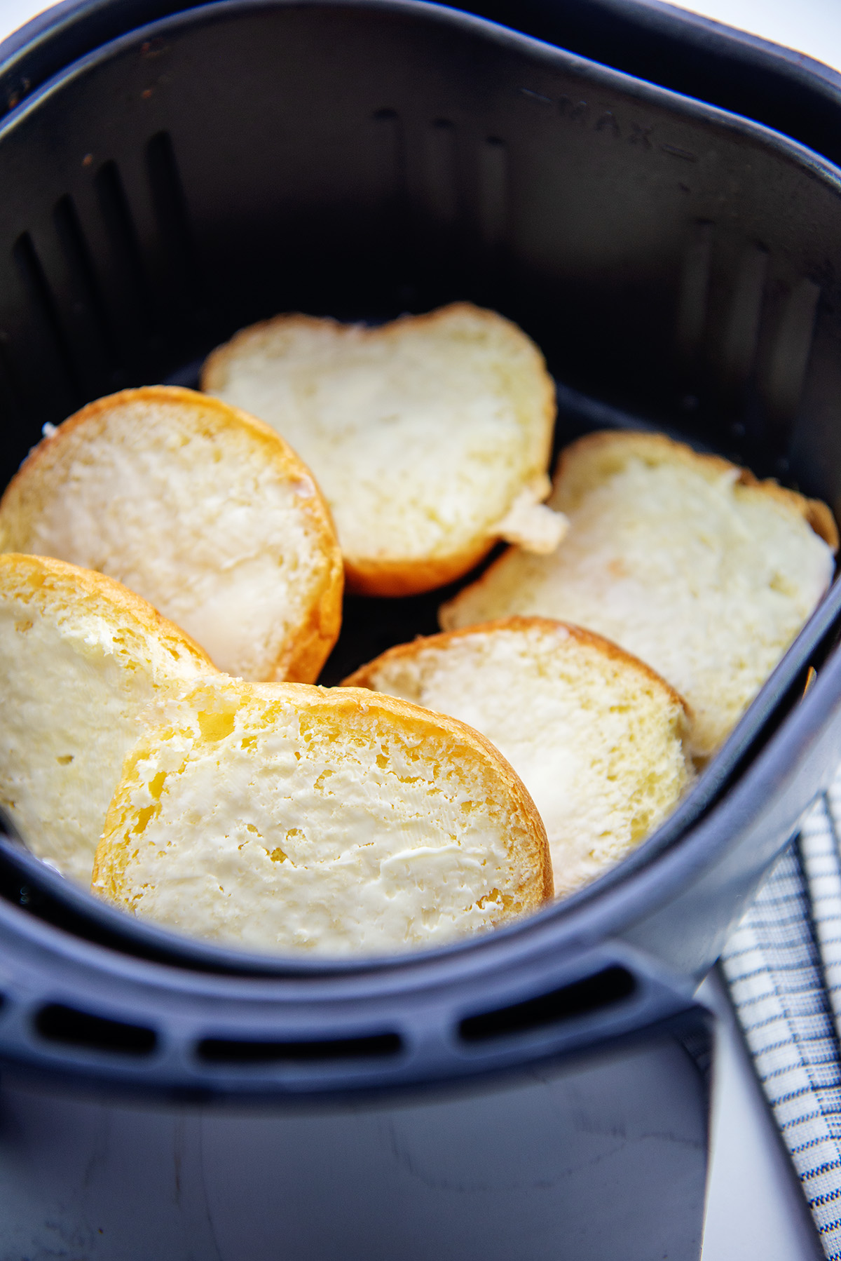 buns stacked up in an air fryer basket