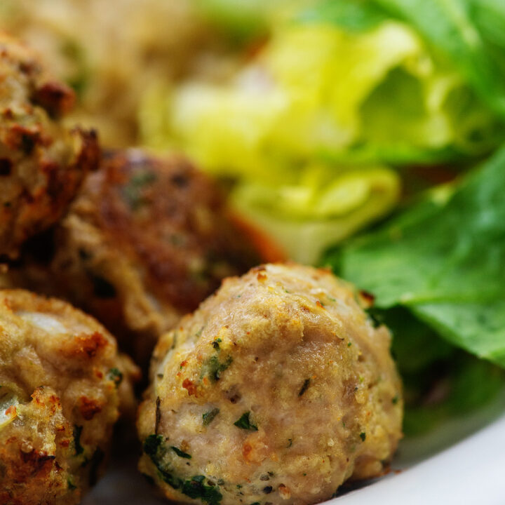 Close up of a stack of turkey meatballs on a white plate