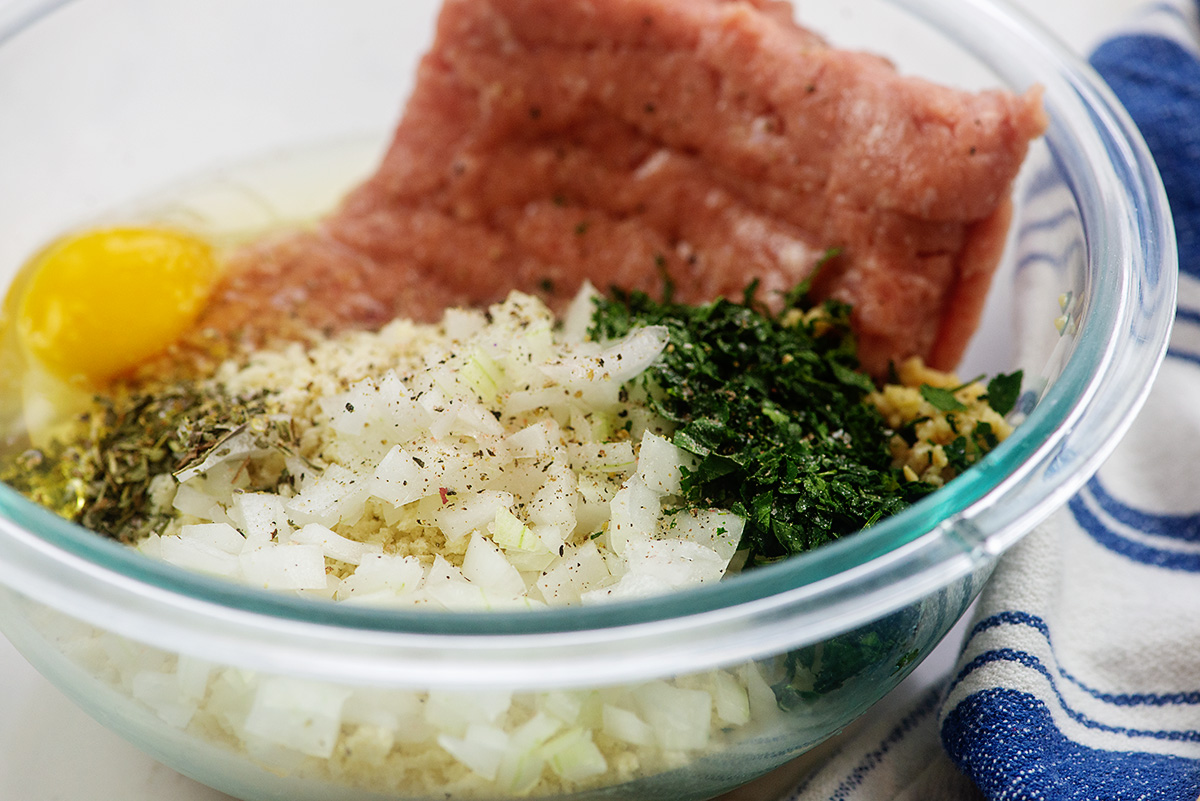 all the ingredients for turkey meatballs in a clear glass bowl