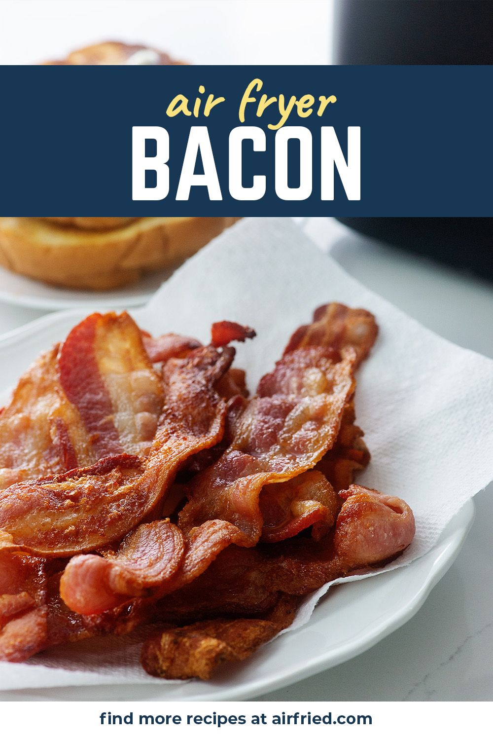 pile of bacon on paper towel lined plate.