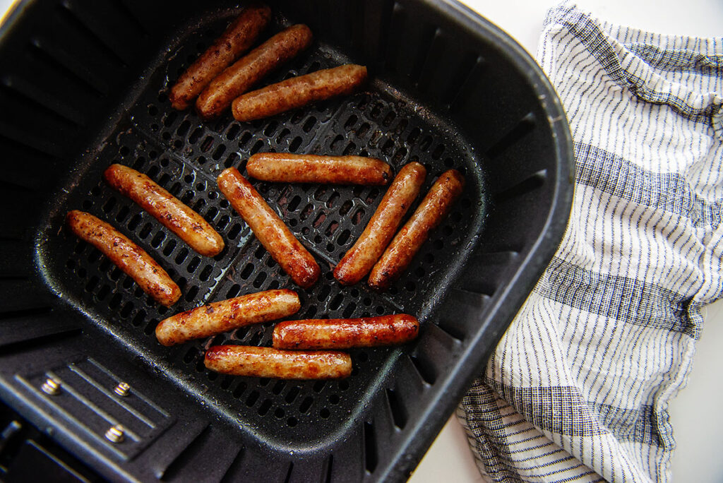 Overhead view of sausage links in an air fryer basket