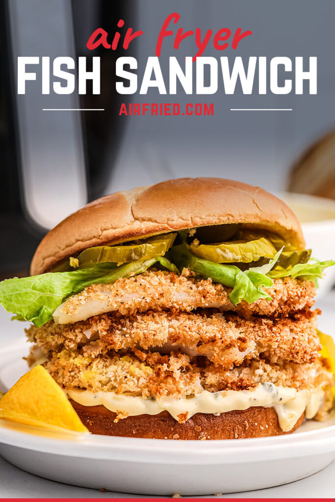 Giant fish sandwich with layerd fillets on a white plate