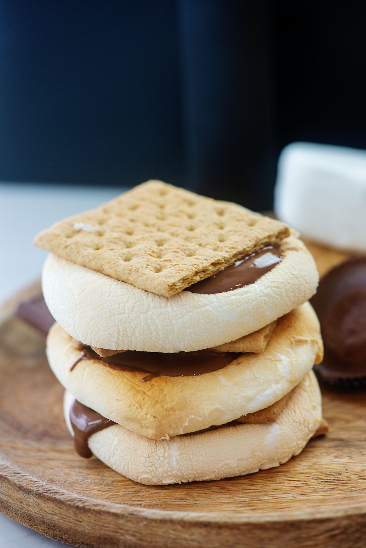 Stacked s'mores on a wooden plate