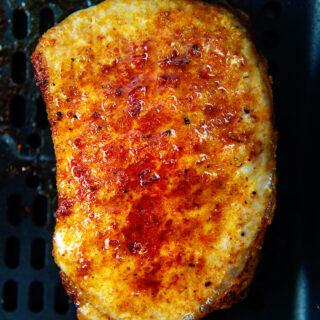 Close up of a cooked pork chop in an air fryer