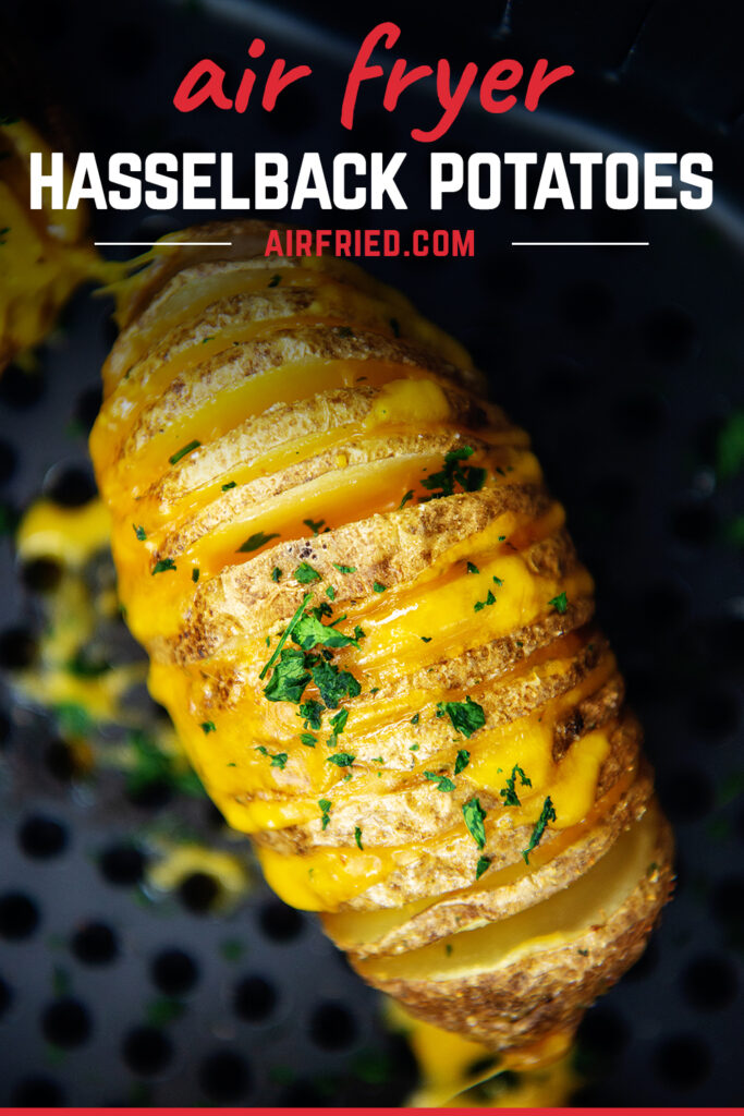 overhead view of a cheesy hasselback potato in an air fryer basket