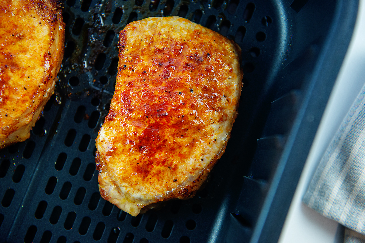 Close up of a pork chop in an air fryer