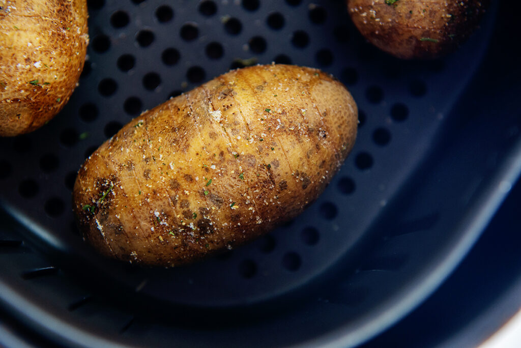 salted potatoes in an air fryer basket