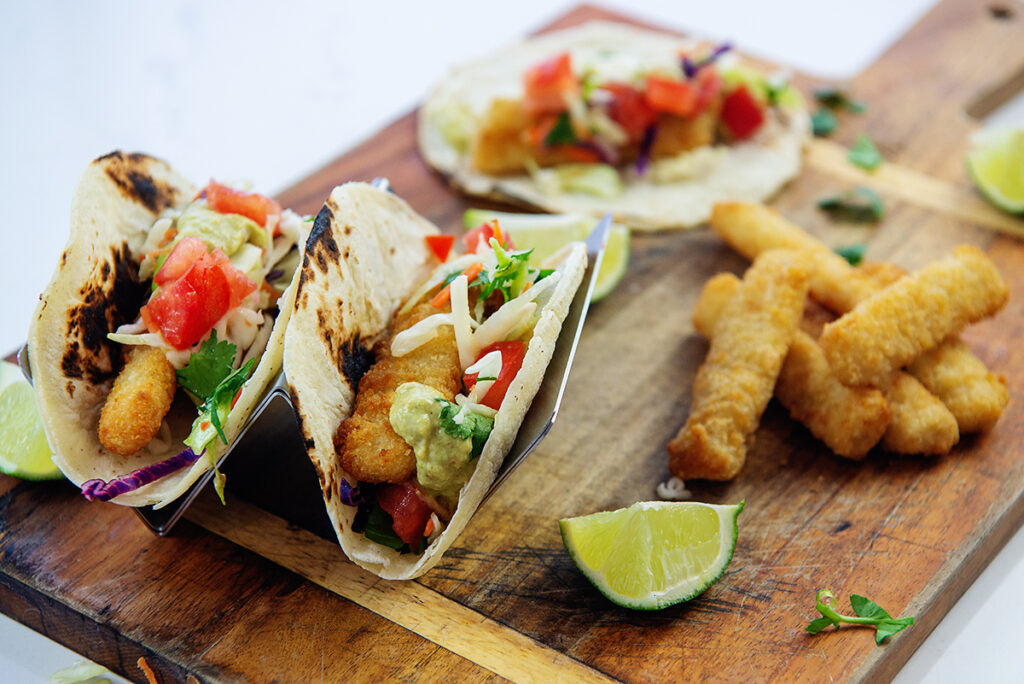 Fish tacos on a wooden cutting board