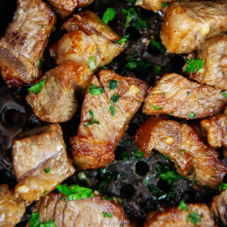 Close up of cooked steak in an air fryer basket
