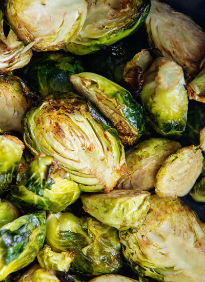 Close up of Brussels sprouts piled up in an air fryer basket