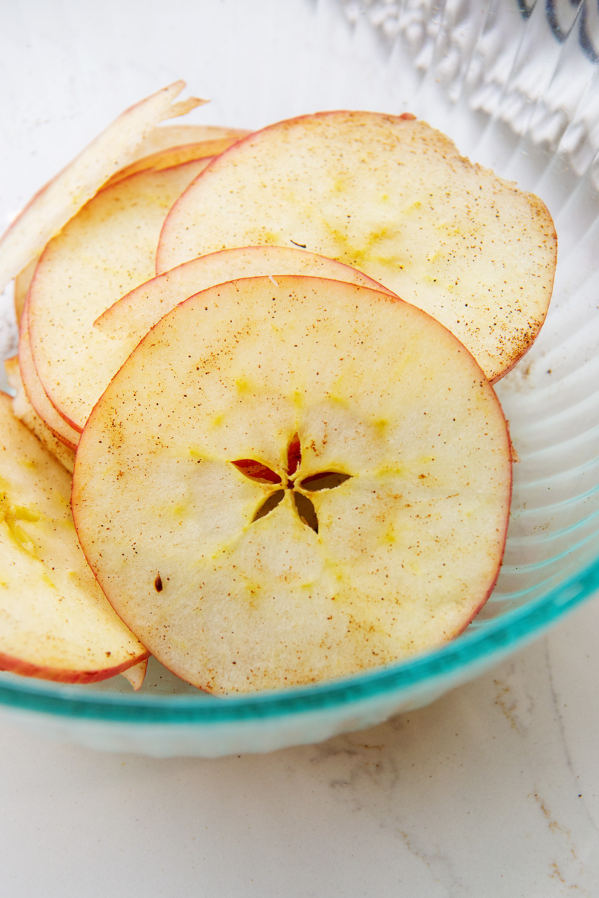 Apple slices in a clear glass bowl