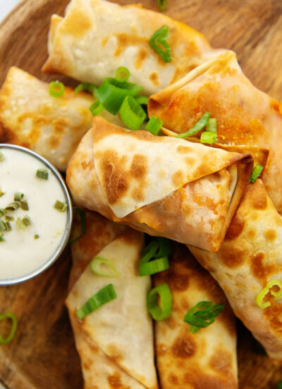Close up of egg rolls topped with green onions