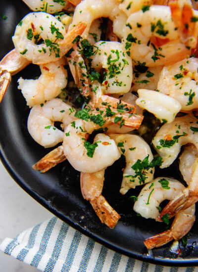 cooked shrimp on black plate.