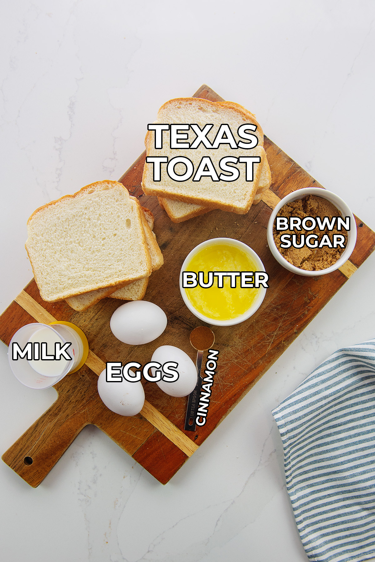 French toast ingredients spread out on a cutting board.