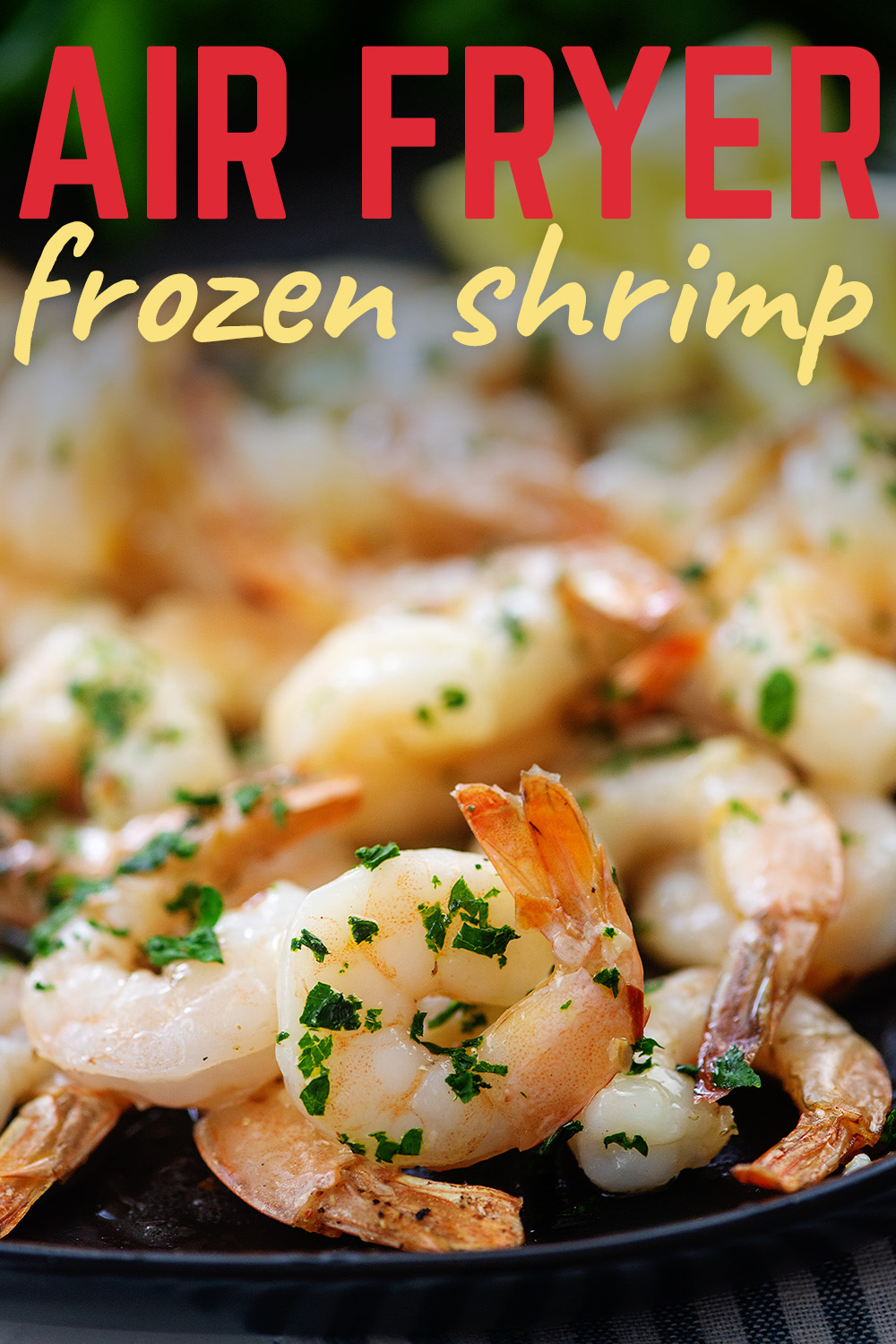 garlic butter shrimp on black plate with text for Pinterest.